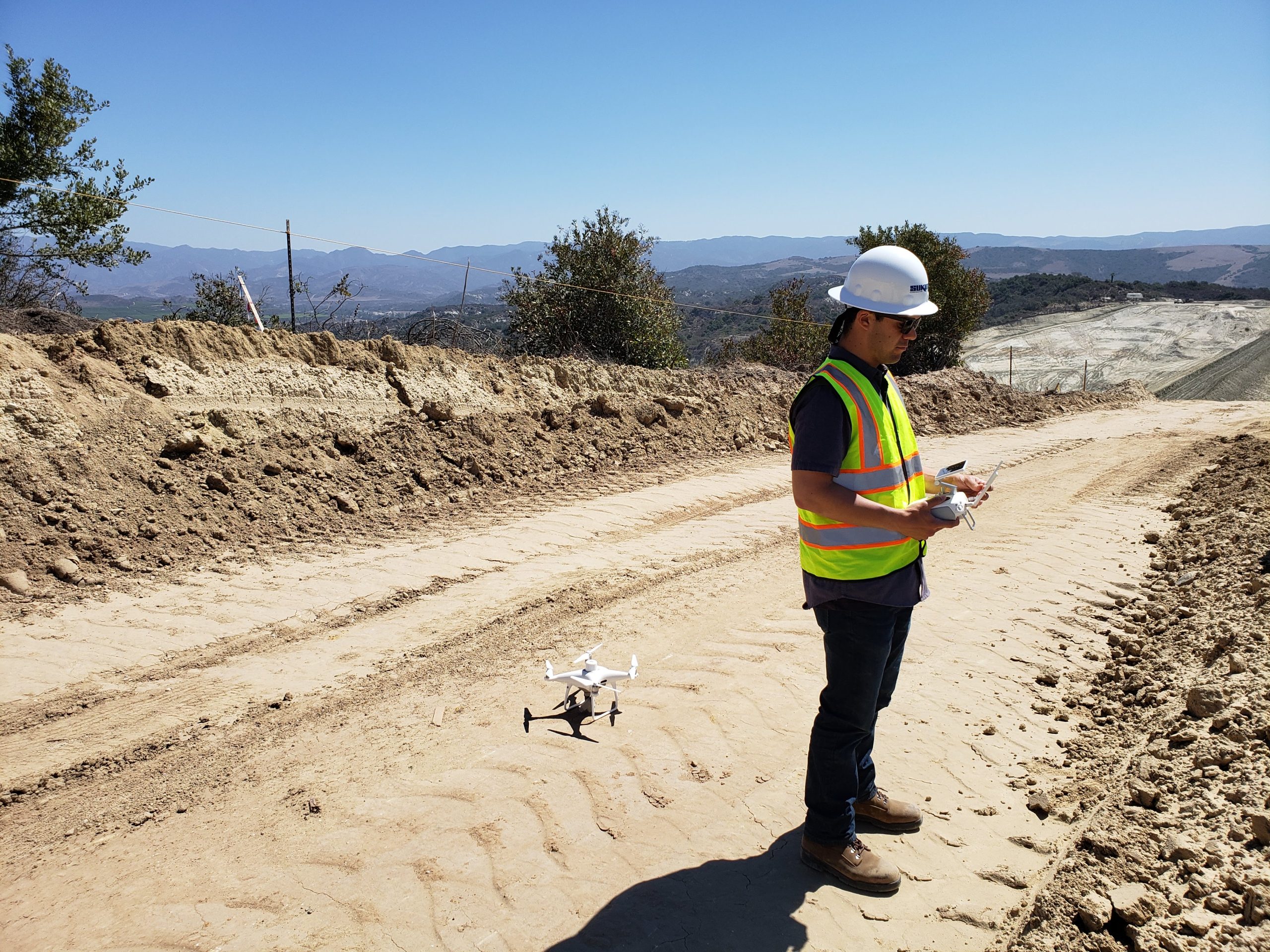drone and construction worker holding drone controller