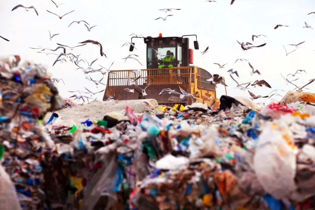 Dozer on landfill compacting trash