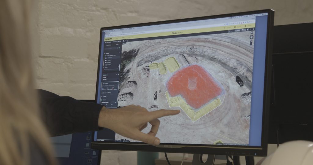 person pointing at screen showing stockpile measurement in propeller platform