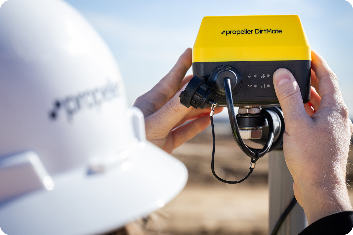 A DirtMate being installed on a pole