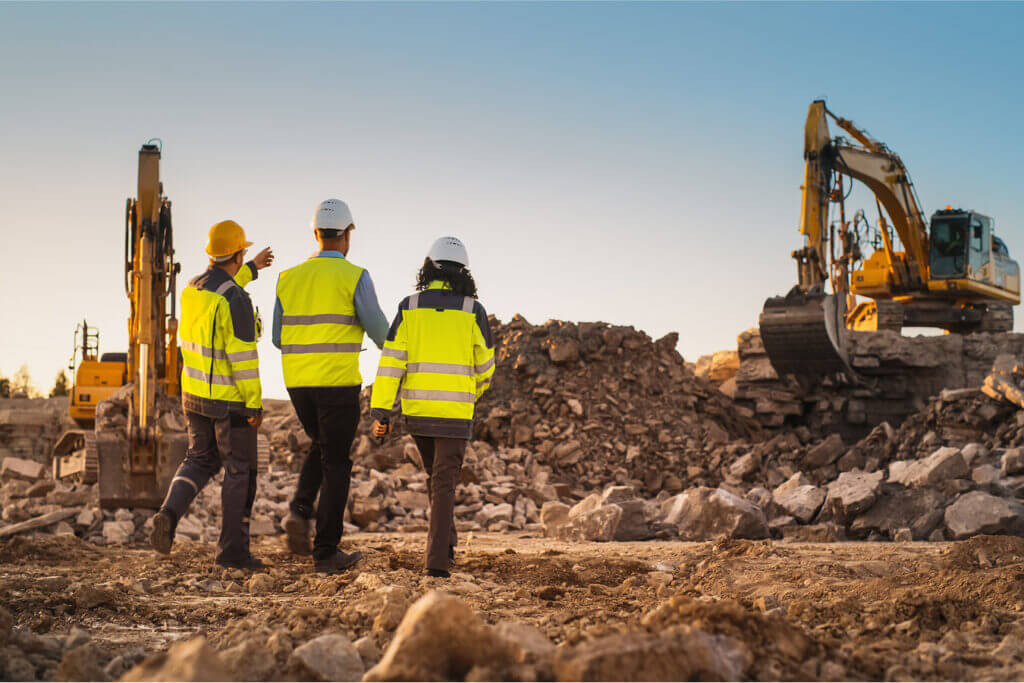 three construction workers inspecting site