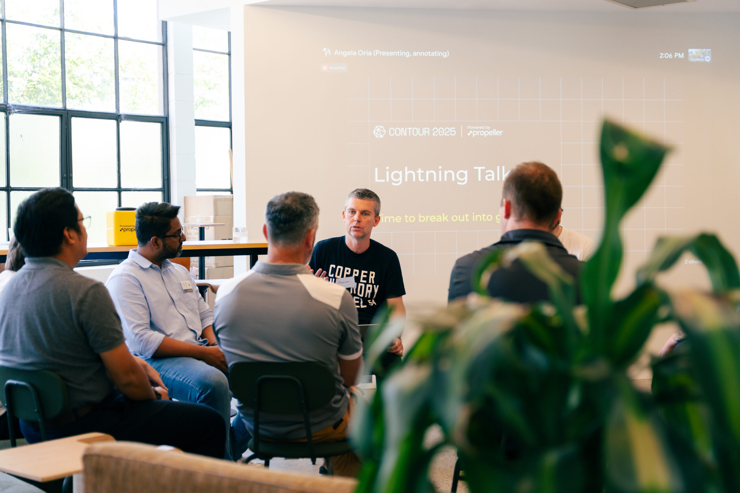 Propeller team members speaking at a conference