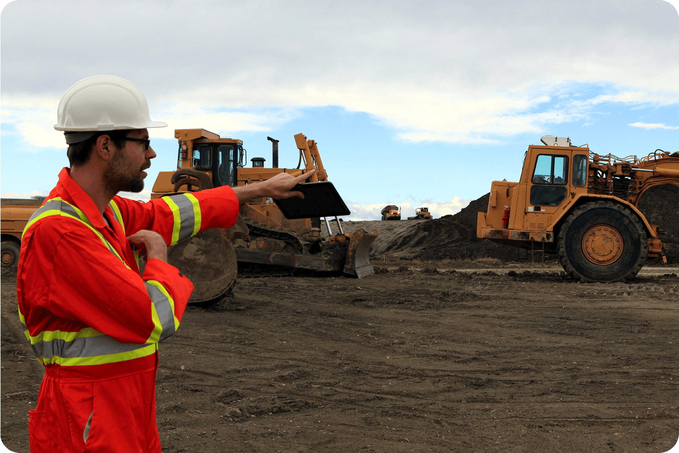 Foremen and superintendent on site pointing at machinery