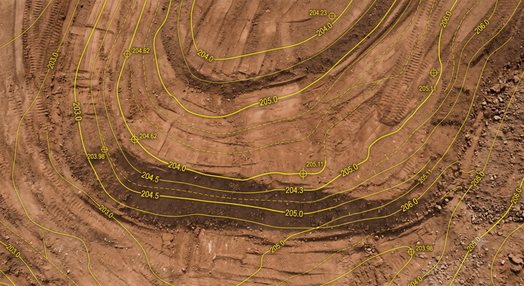 Graded earth surface with a cut/fill design overlay of contour lines and grade markers